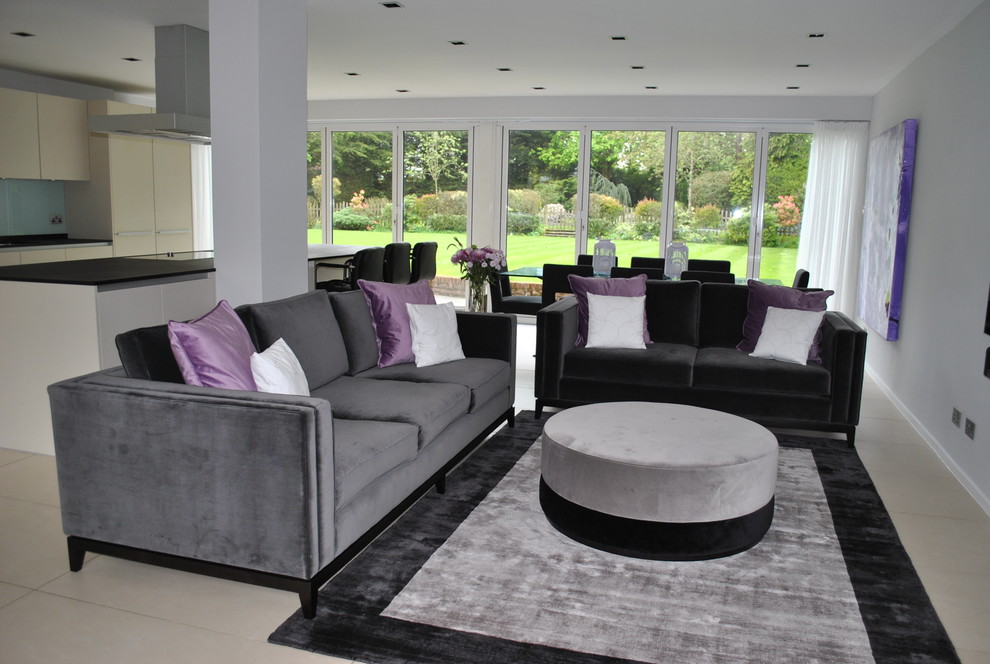 Living room - mid-sized modern open concept living room idea in Hertfordshire with gray walls and a wall-mounted tv