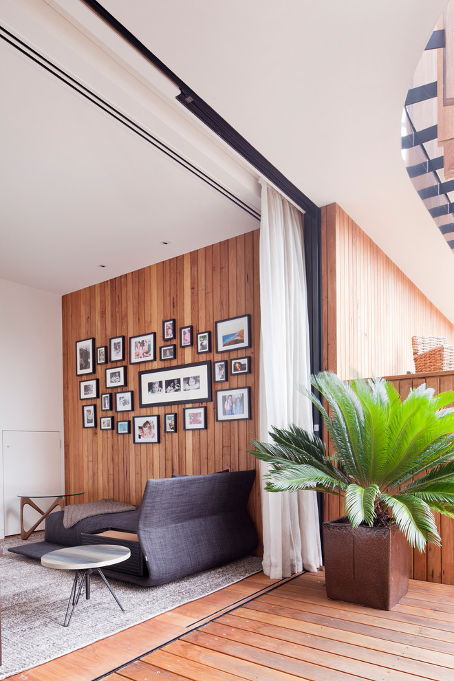 Photo of a contemporary living room in Melbourne with medium hardwood flooring.