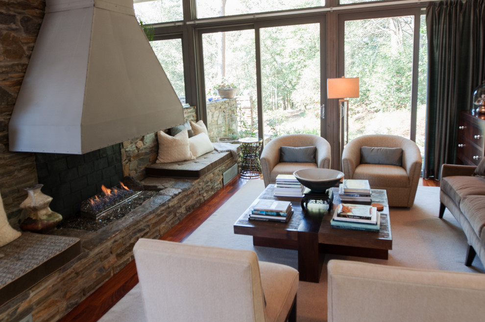 Example of a mid-sized transitional open concept medium tone wood floor living room design in Atlanta with brown walls, a standard fireplace, a stone fireplace and no tv