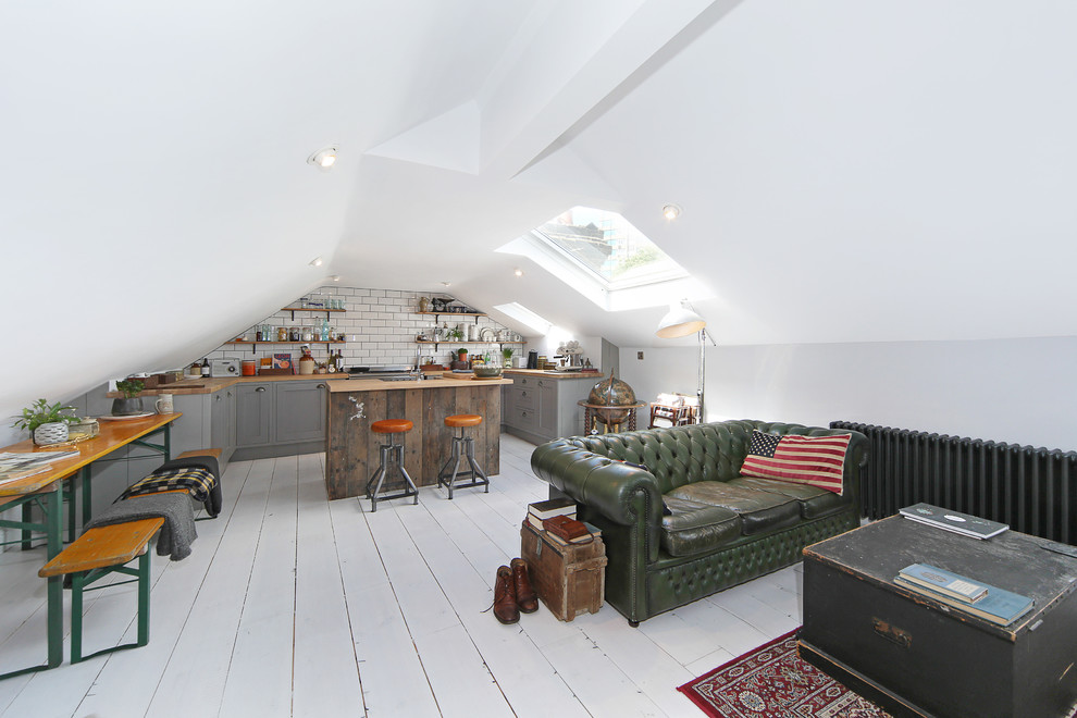 Small scandi open plan living room in London with light hardwood flooring and white floors.