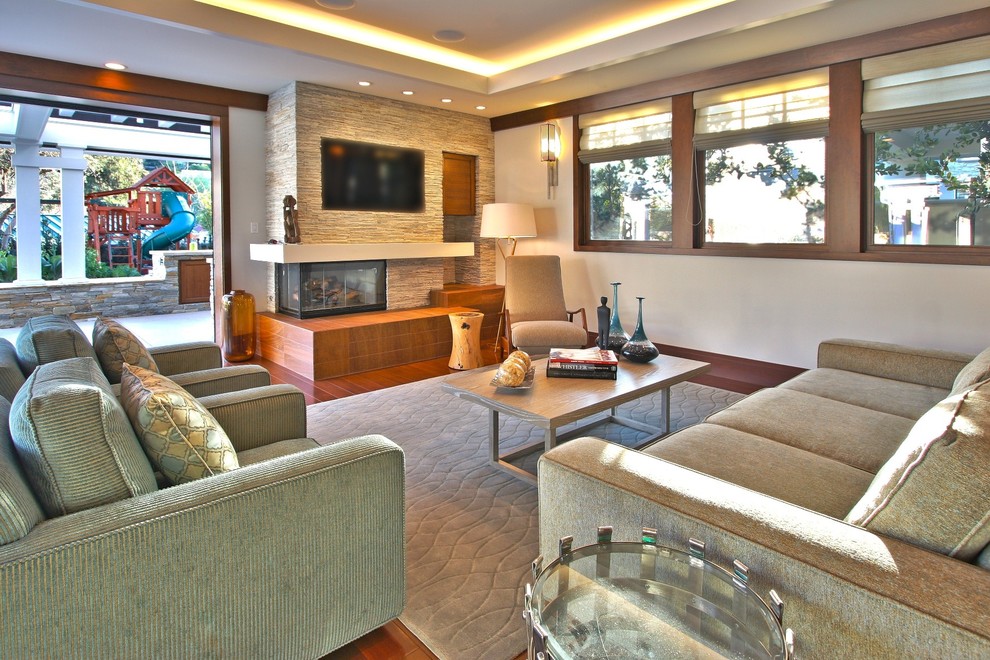 Trendy living room photo in Los Angeles with a corner fireplace and a stone fireplace