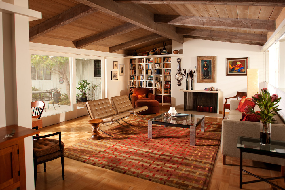 Eclectic medium tone wood floor living room photo in San Diego with beige walls