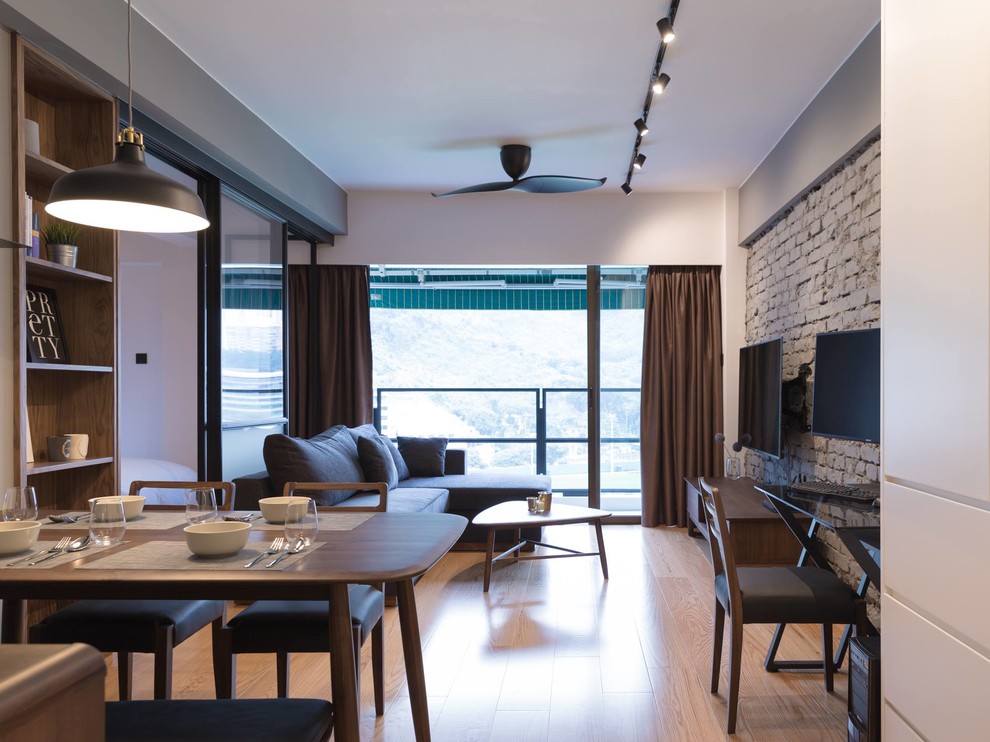 Small urban living room in Hong Kong with grey walls, plywood flooring and a wall mounted tv.