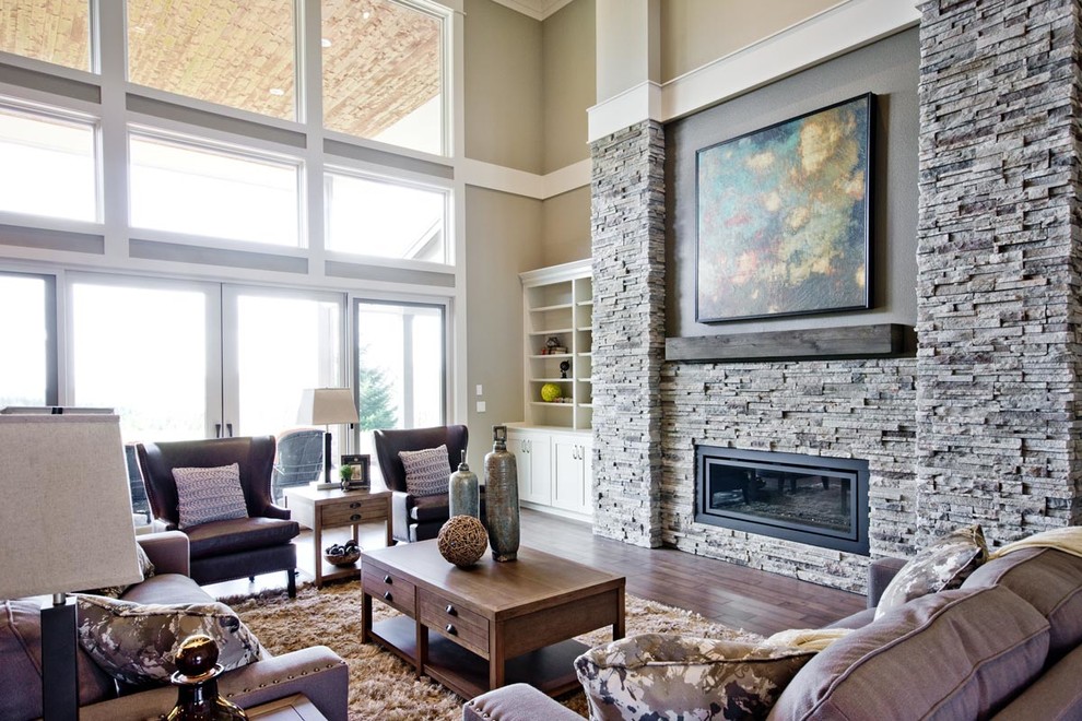 Inspiration for a large traditional open plan living room in Portland with beige walls, medium hardwood flooring, a standard fireplace and a stone fireplace surround.