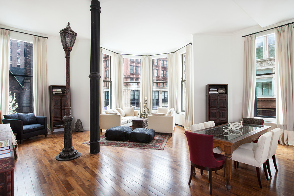 Inspiration for a contemporary open concept medium tone wood floor living room remodel in New York with white walls