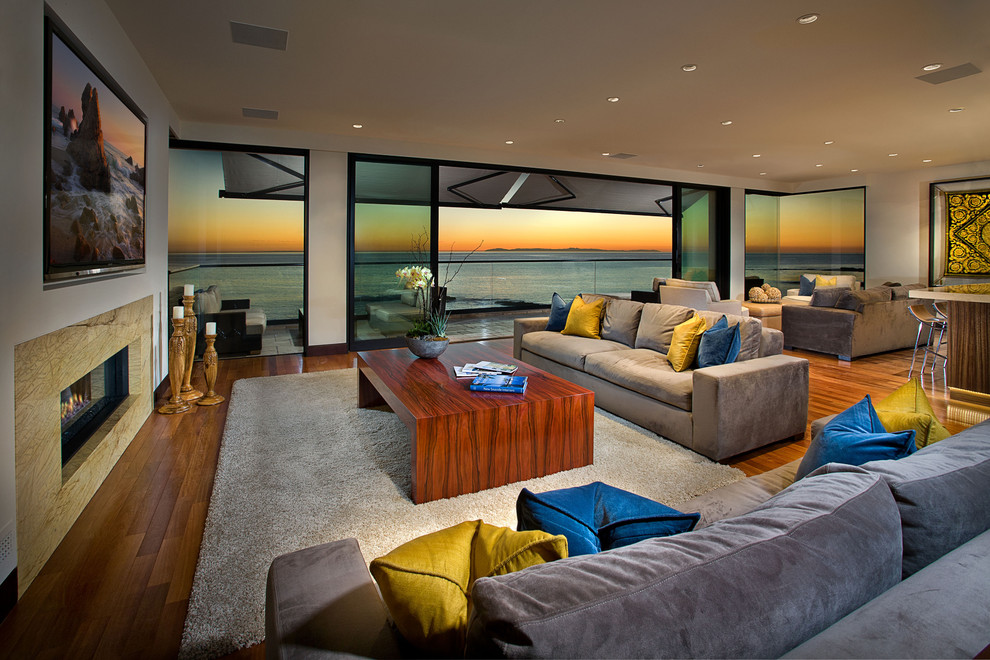 Contemporary open plan living room in Orange County with a ribbon fireplace.