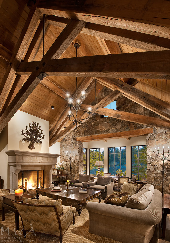 Design ideas for a large rustic formal open plan living room in Other with beige walls, dark hardwood flooring, a standard fireplace, a plastered fireplace surround and brown floors.