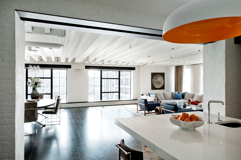 Inspiration for an industrial open concept black floor living room remodel in New York with white walls