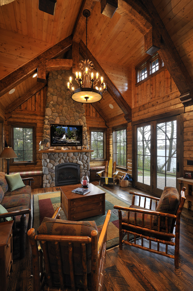Inspiration for a large rustic living room remodel in Minneapolis with a standard fireplace and a stone fireplace
