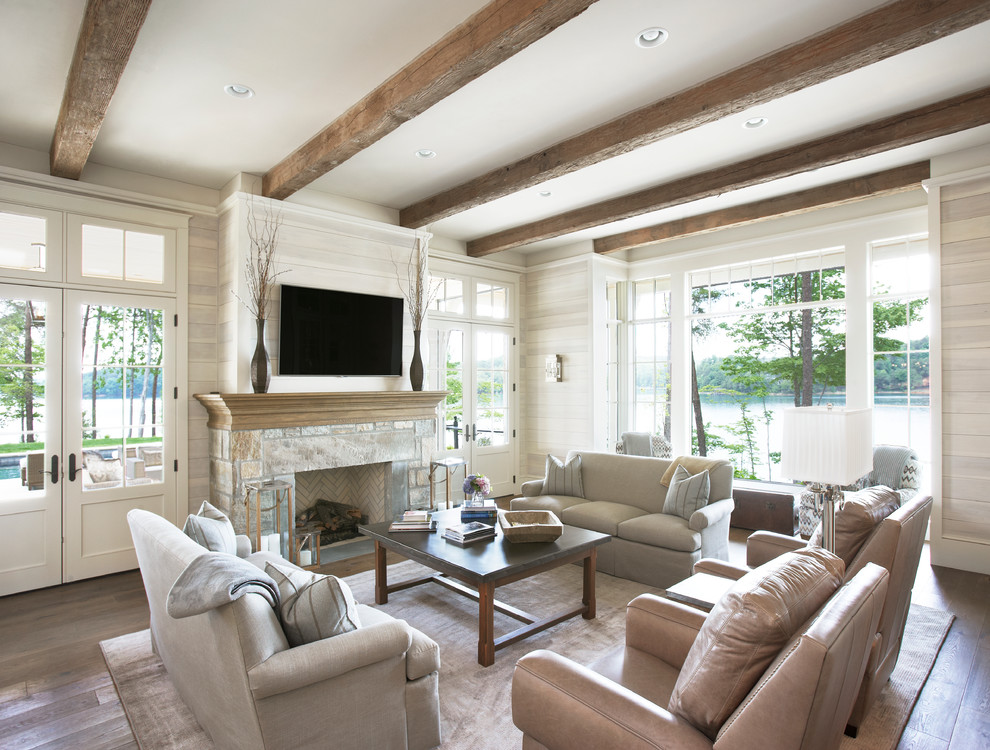 Inspiration for a timeless formal and open concept medium tone wood floor living room remodel in Other with beige walls, a standard fireplace, a stone fireplace and a wall-mounted tv