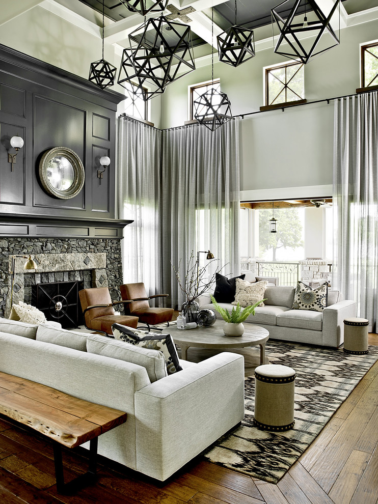 Transitional formal medium tone wood floor living room photo in Milwaukee with gray walls, a standard fireplace and a stone fireplace