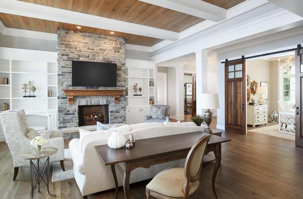 Inspiration for a nautical open plan living room in Grand Rapids with grey walls, medium hardwood flooring, a standard fireplace, a stone fireplace surround, a wall mounted tv, brown floors and a timber clad ceiling.
