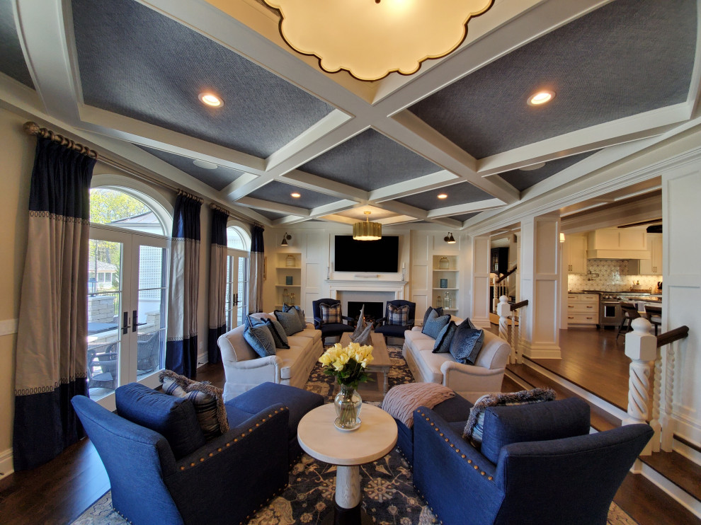 Living room - traditional formal and open concept dark wood floor, brown floor, coffered ceiling and wall paneling living room idea in Milwaukee with white walls, a standard fireplace, a wood fireplace surround and a wall-mounted tv