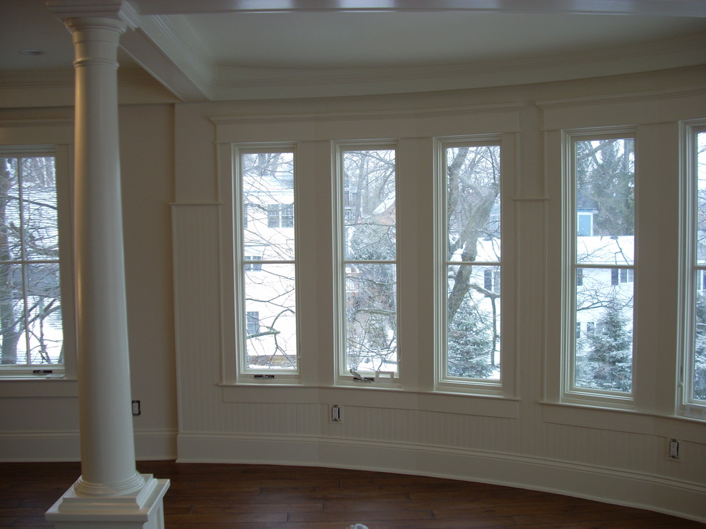 Photo of a large traditional enclosed living room in Milwaukee with white walls.