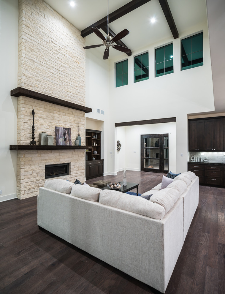 Large traditional formal open plan living room in Austin with white walls, dark hardwood flooring, a ribbon fireplace, a stone fireplace surround and no tv.