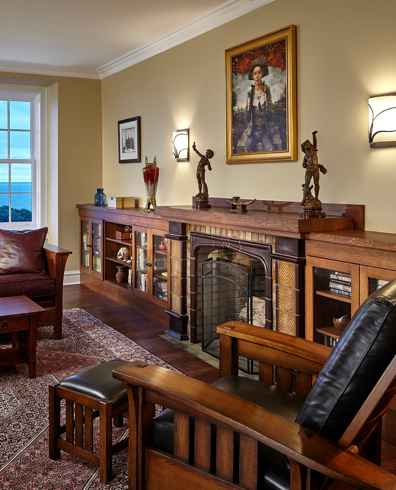 This is an example of a traditional living room in Chicago with beige walls, dark hardwood flooring, a standard fireplace and a tiled fireplace surround.