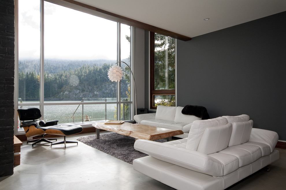 Large trendy concrete floor living room photo in Vancouver with black walls