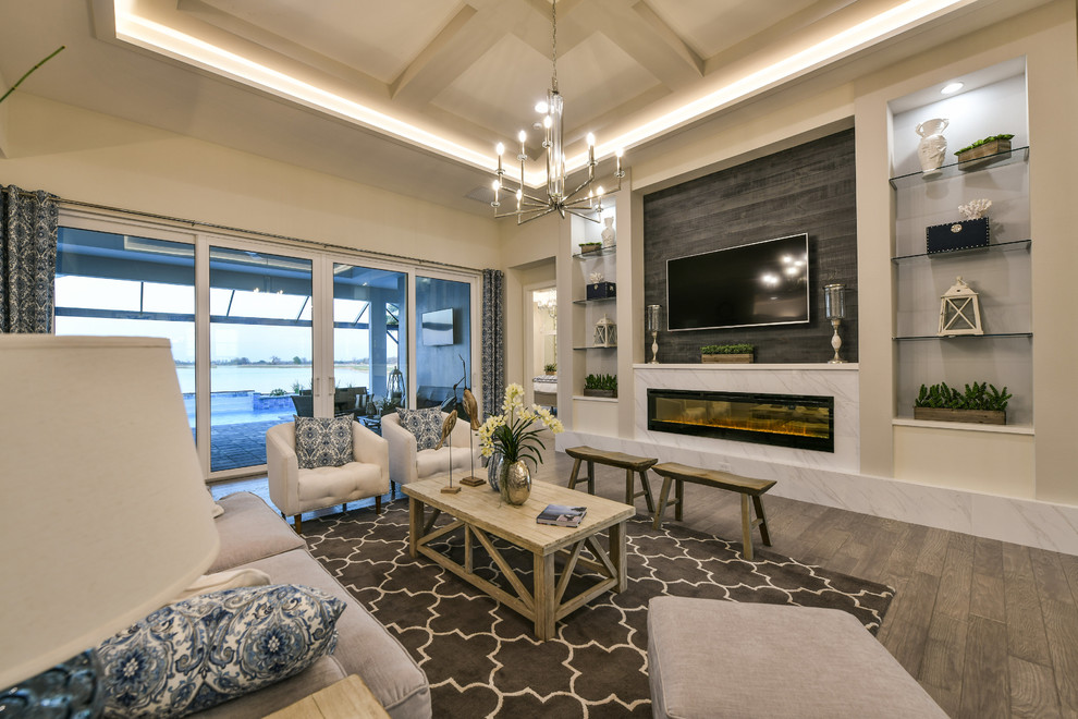 Example of a large beach style open concept living room design in Other with beige walls, a ribbon fireplace, a stone fireplace and a wall-mounted tv