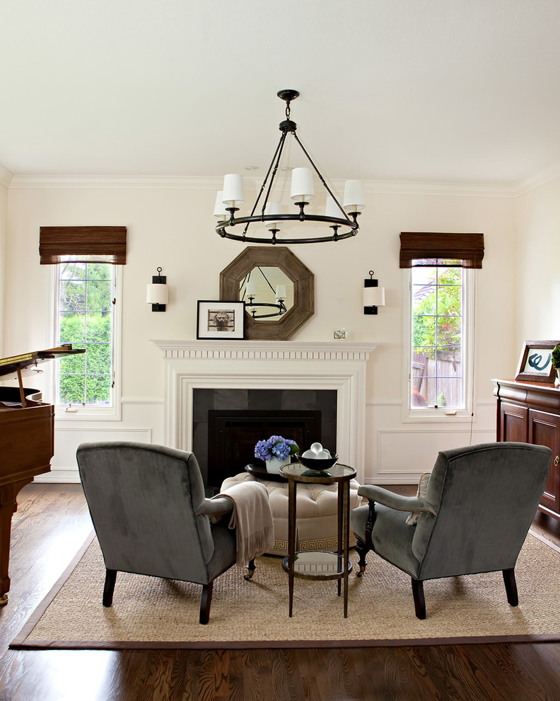 Example of a classic dark wood floor living room design in Seattle with a music area, white walls and a standard fireplace