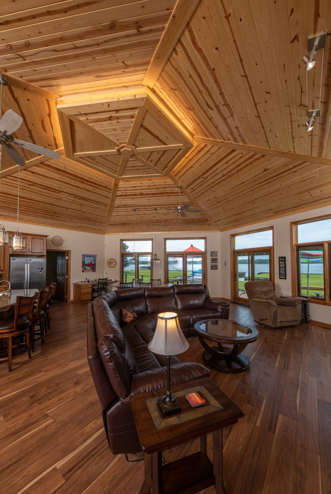 Traditional open plan living room in Grand Rapids with dark hardwood flooring and brown floors.