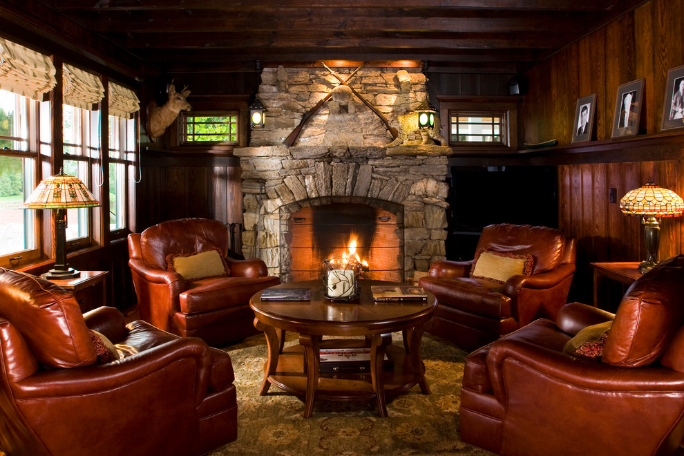 This is an example of a medium sized rustic formal enclosed living room in Boston with brown walls, medium hardwood flooring, a standard fireplace and a stone fireplace surround.