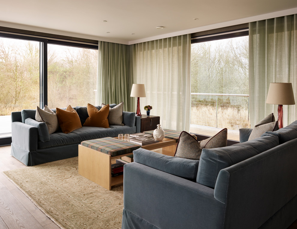 Photo of a contemporary formal open plan living room in Gloucestershire with light hardwood flooring and beige floors.