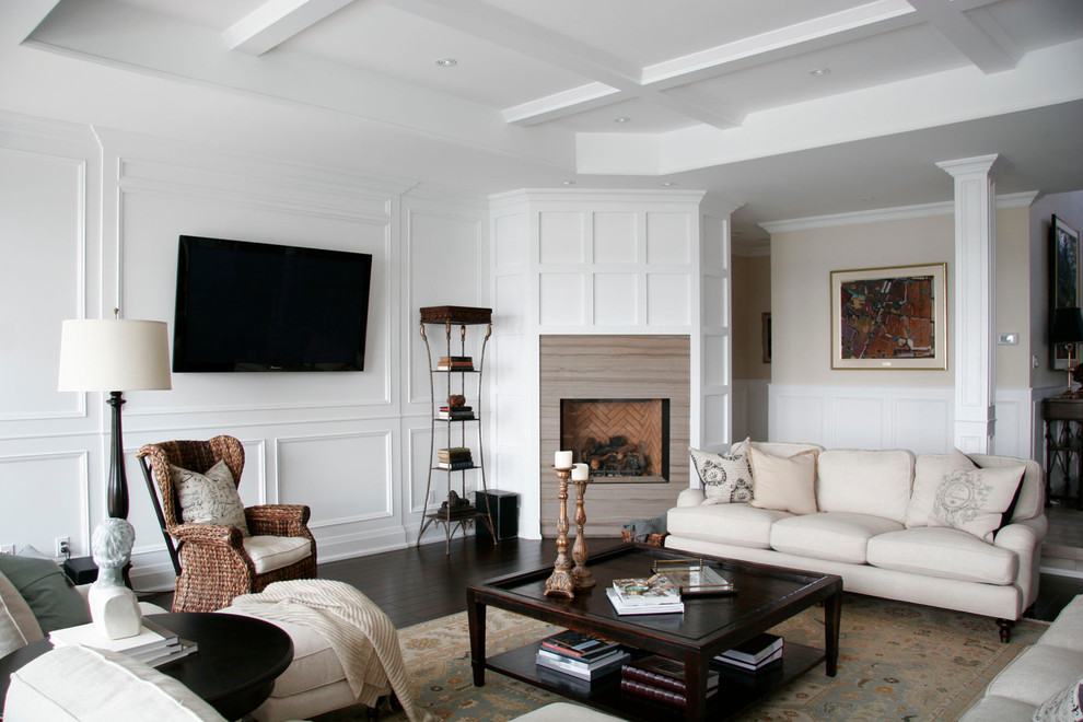 This is an example of a medium sized traditional formal open plan living room in Toronto with white walls, a wall mounted tv, dark hardwood flooring, a standard fireplace, a stone fireplace surround and brown floors.
