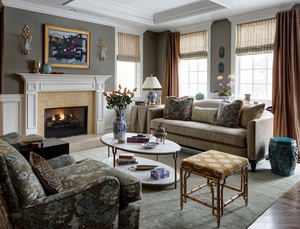Photo of a medium sized traditional formal open plan living room curtain in Chicago with grey walls, a standard fireplace, a tiled fireplace surround, medium hardwood flooring and brown floors.