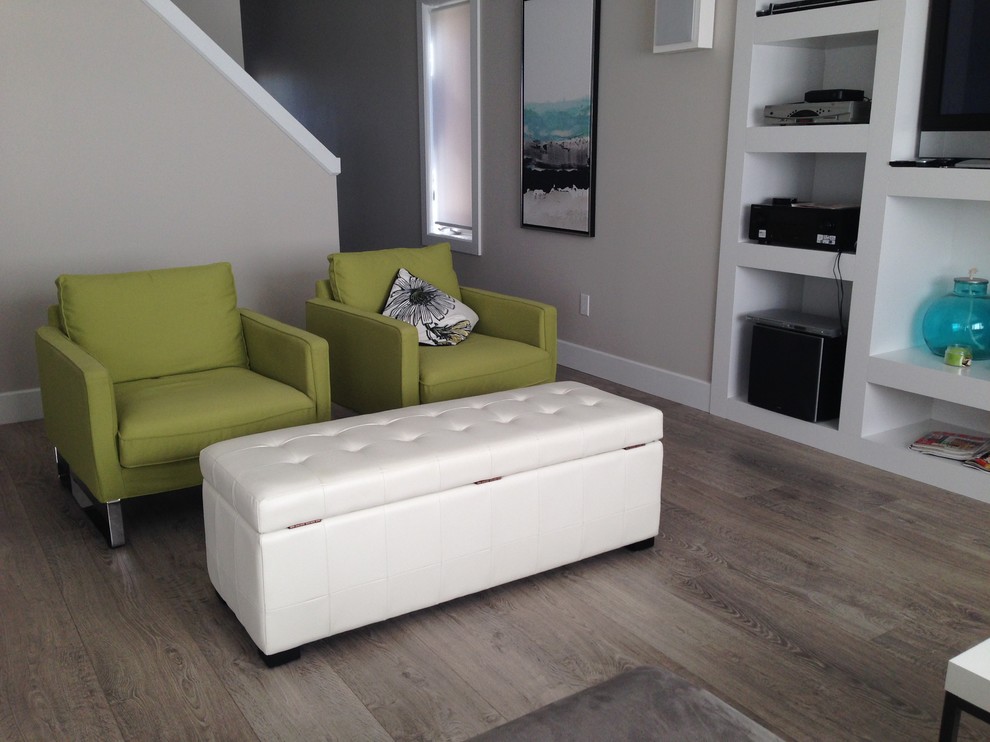 Photo of a medium sized modern enclosed living room in Toronto with grey walls, laminate floors and a built-in media unit.
