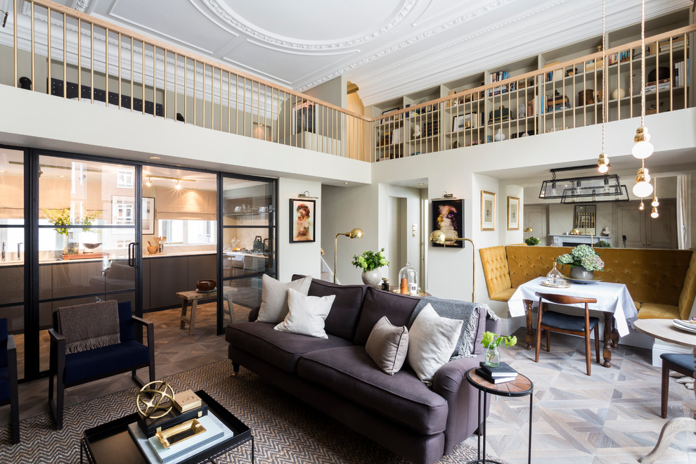 Example of a large transitional open concept and formal medium tone wood floor living room design in London with white walls