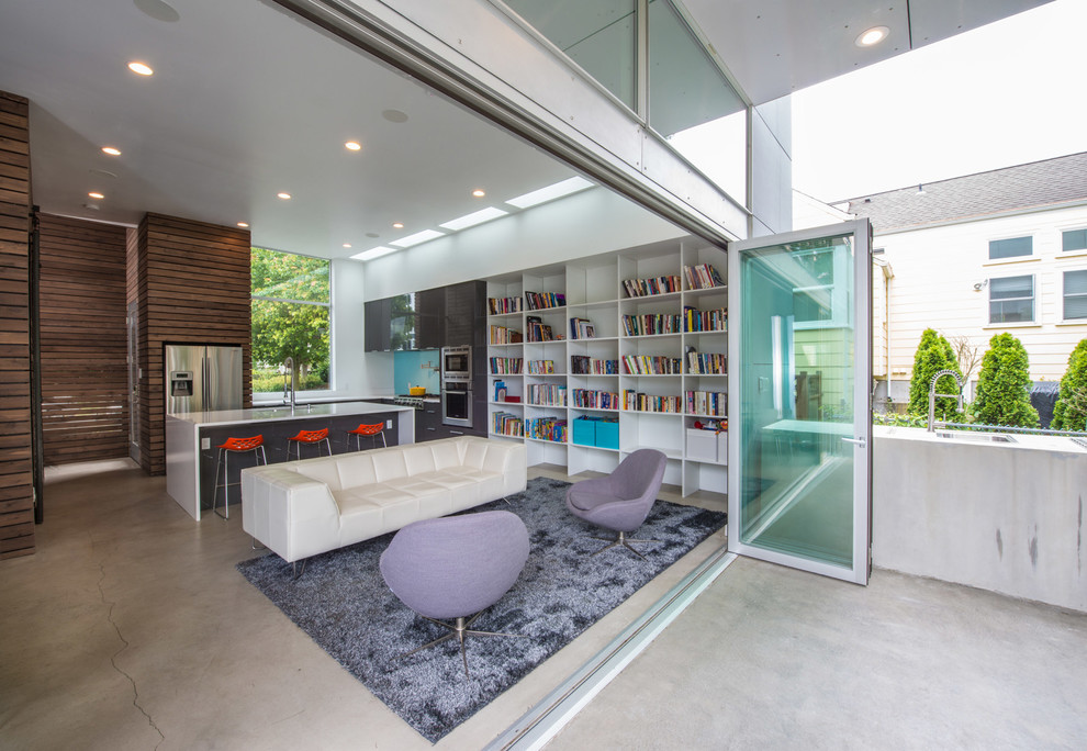 Mid-sized trendy open concept concrete floor living room library photo in Seattle with white walls, no tv and no fireplace