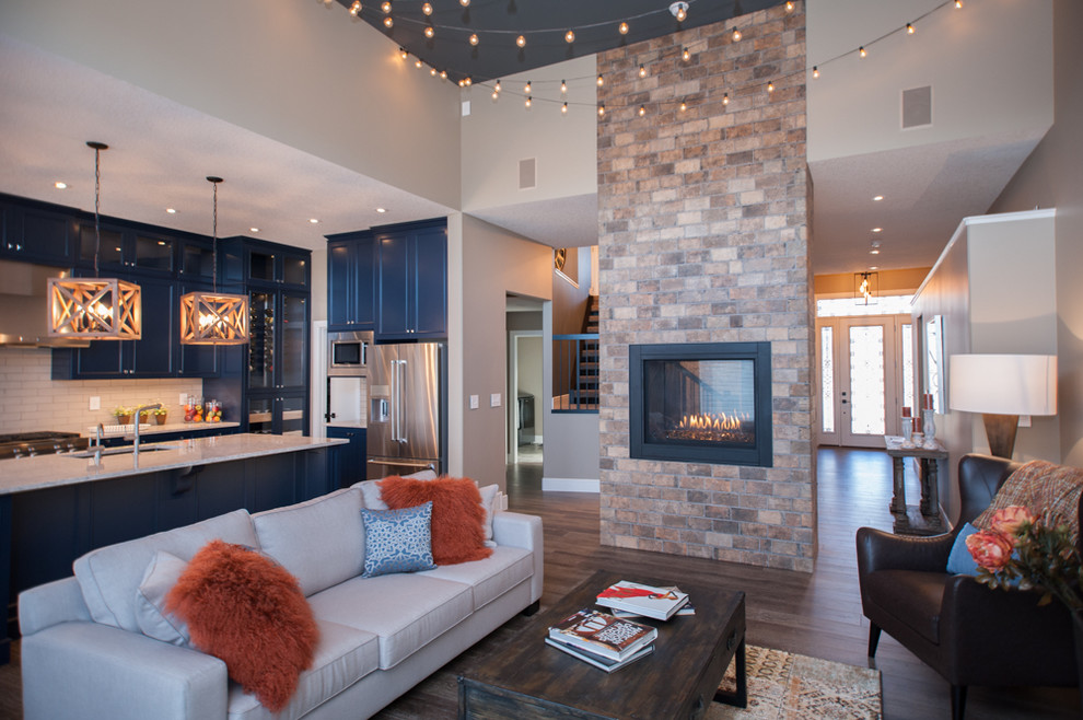 Large trendy formal and open concept living room photo in Calgary with beige walls, a two-sided fireplace, a brick fireplace and a wall-mounted tv