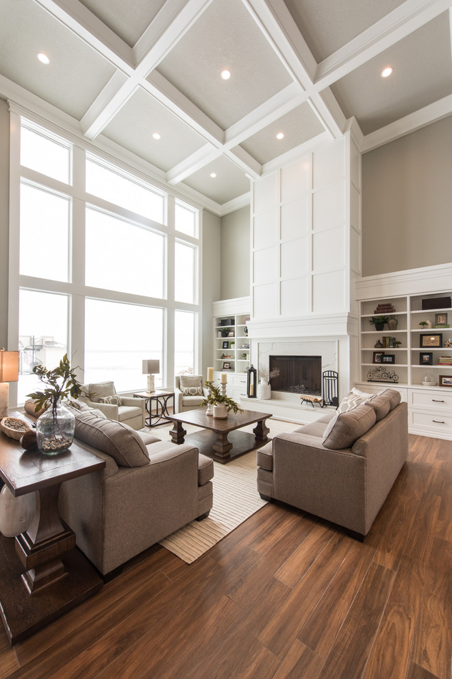 Example of a transitional open concept medium tone wood floor and brown floor living room design in Salt Lake City with beige walls, a standard fireplace and a wood fireplace surround