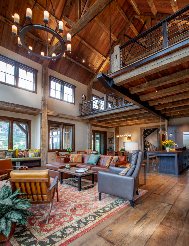 Photo of a rustic open plan living room in Denver with beige walls, medium hardwood flooring, brown floors, a vaulted ceiling and a wood ceiling.