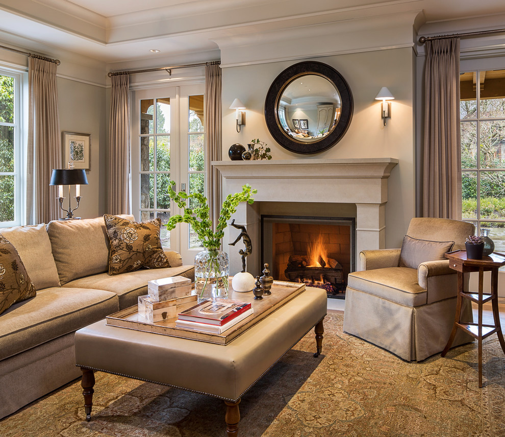 Inspiration for a large timeless enclosed medium tone wood floor and brown floor living room remodel in Vancouver with beige walls, a standard fireplace, a stone fireplace and no tv
