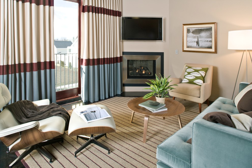 Источник вдохновения для домашнего уюта: маленькая изолированная гостиная комната в современном стиле с угловым камином, телевизором на стене, бежевыми стенами, полом из сланца, фасадом камина из металла и синим диваном для на участке и в саду