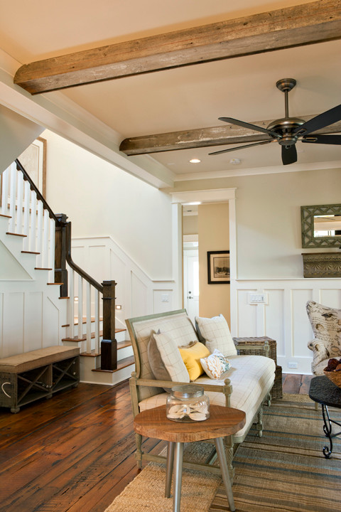 Inspiration for a mid-sized coastal enclosed medium tone wood floor living room remodel in Charleston with beige walls