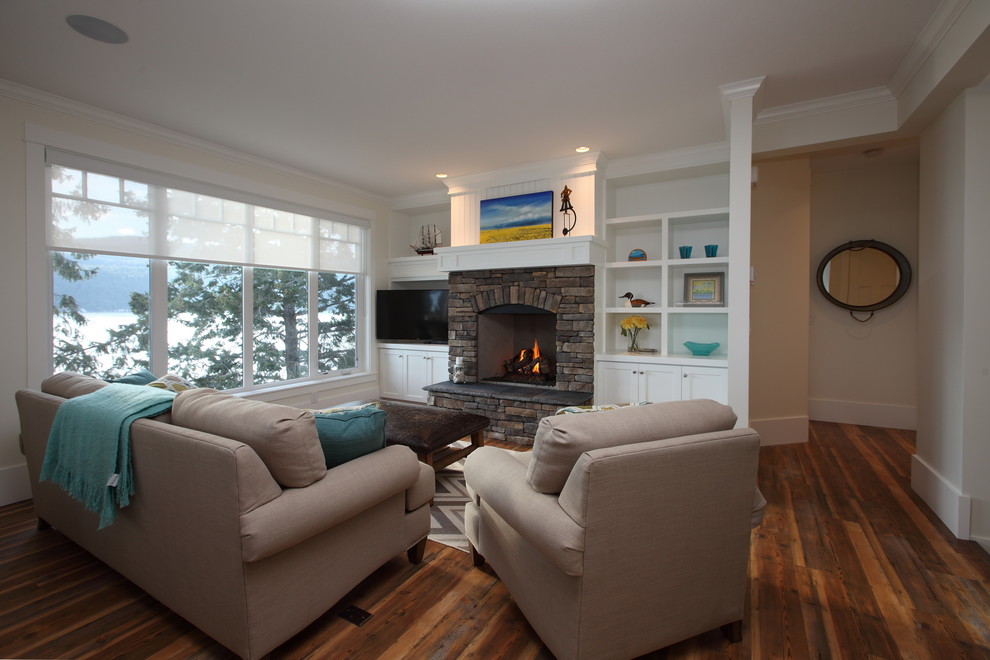 Inspiration for a medium sized contemporary open plan living room in Vancouver with white walls, medium hardwood flooring, a standard fireplace, a stone fireplace surround and a freestanding tv.