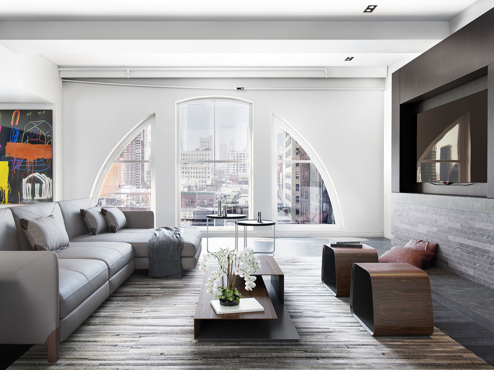 Foto di un soggiorno minimal di medie dimensioni e stile loft con pareti grigie, parete attrezzata e parquet scuro