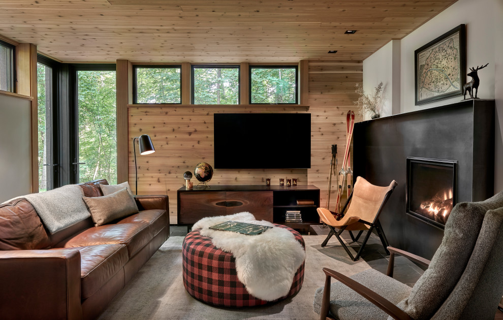 Photo of a large rustic grey and brown enclosed living room in Chicago with beige walls, slate flooring, a standard fireplace, a metal fireplace surround, a wall mounted tv, black floors, a wood ceiling and wood walls.