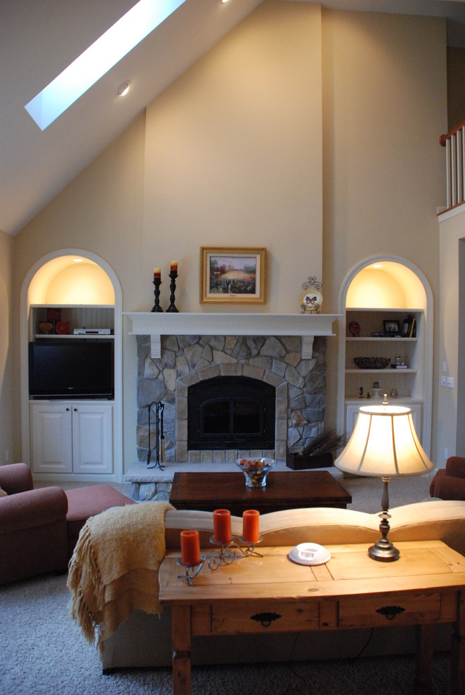 Example of a mid-sized classic open concept carpeted living room design in Milwaukee with beige walls, a wood stove and a stone fireplace