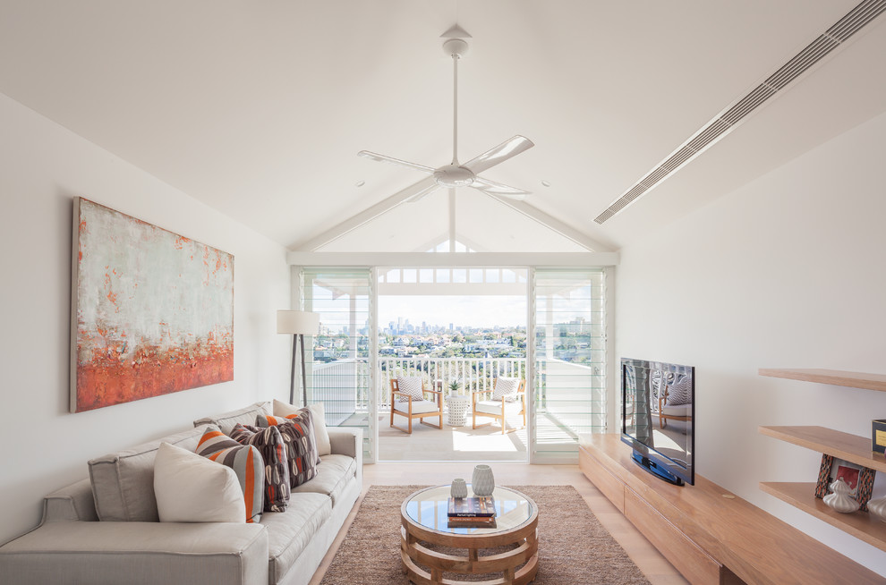 Photo of a scandinavian living room in Sydney with white walls and a freestanding tv.