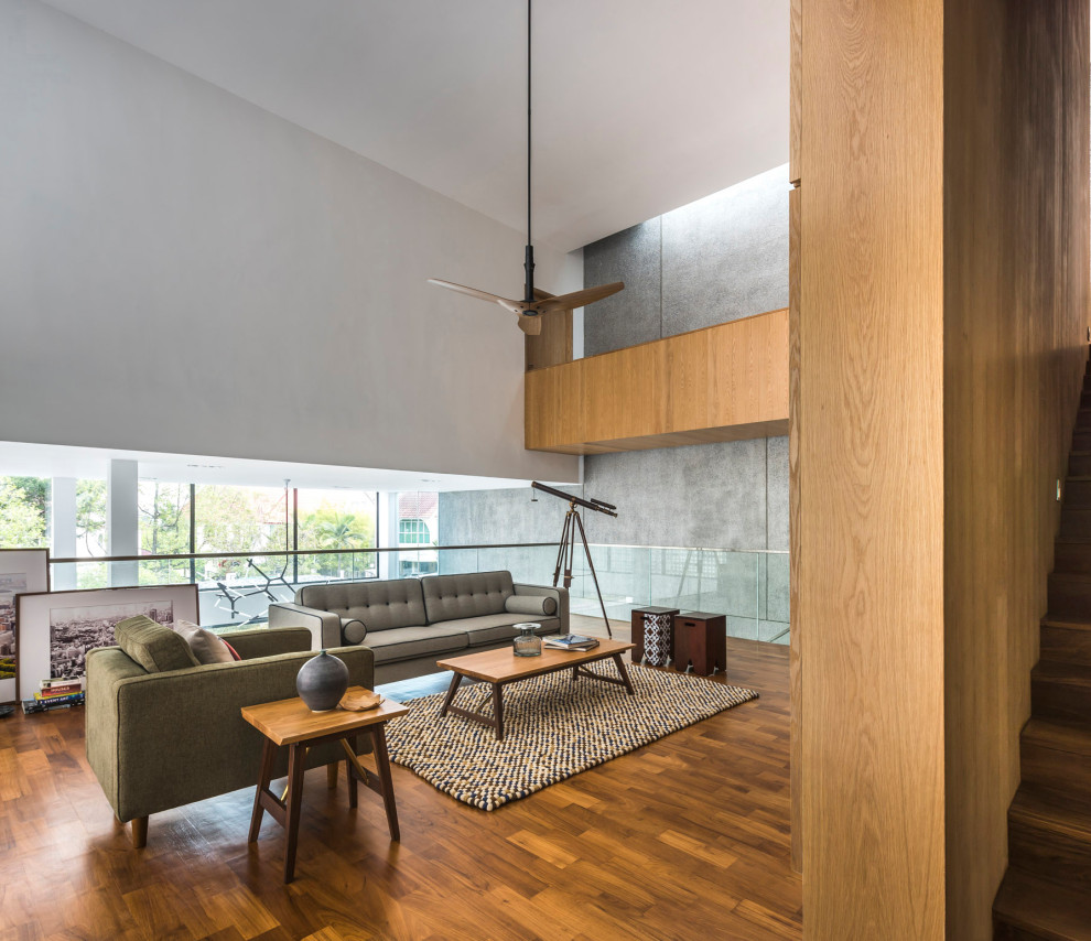 Esempio di un grande soggiorno design aperto con pareti grigie, pavimento in legno massello medio e pavimento grigio