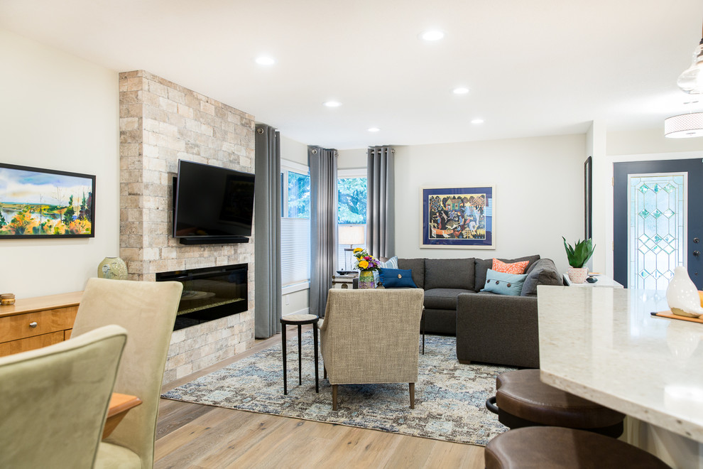 Example of a small transitional open concept medium tone wood floor living room design in Edmonton with gray walls, a standard fireplace and a tile fireplace