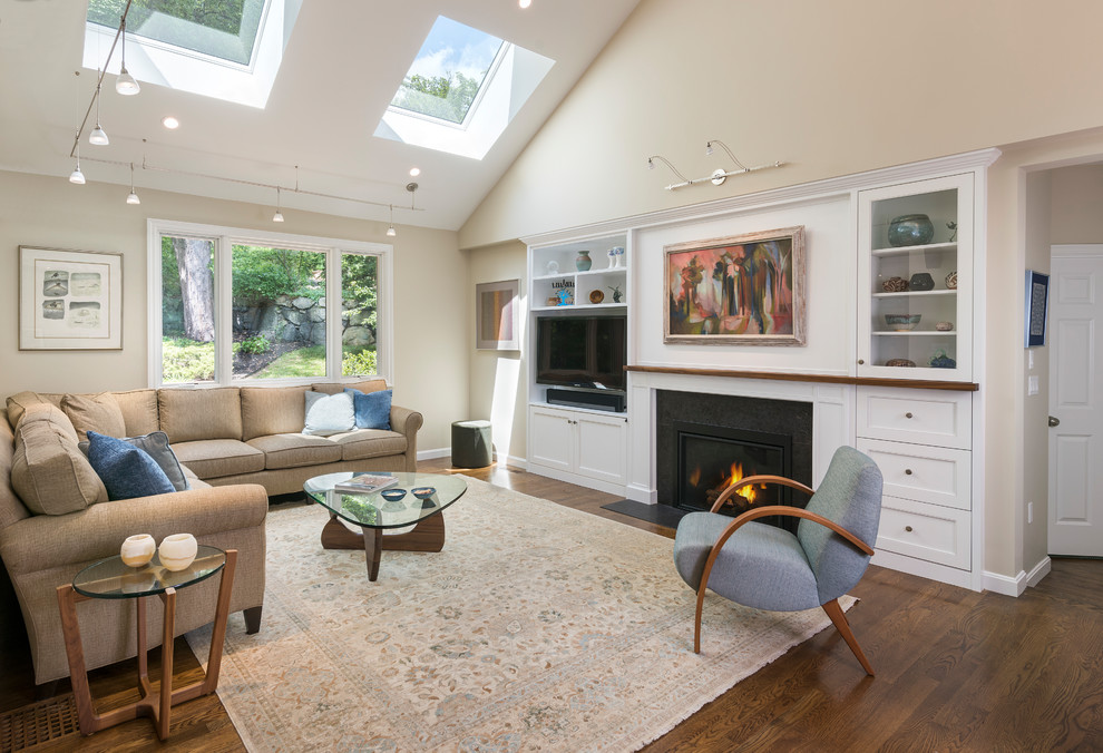 Classic formal open plan living room in Boston with beige walls, a freestanding tv, dark hardwood flooring, a standard fireplace and brown floors.