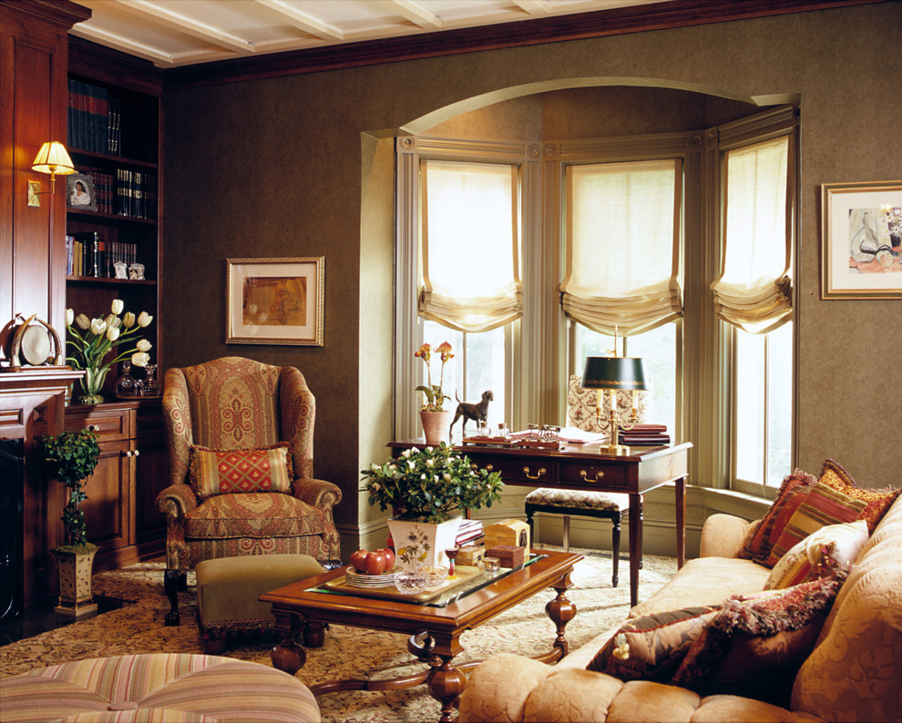 Example of a classic carpeted living room library design in New York with a standard fireplace and brown walls