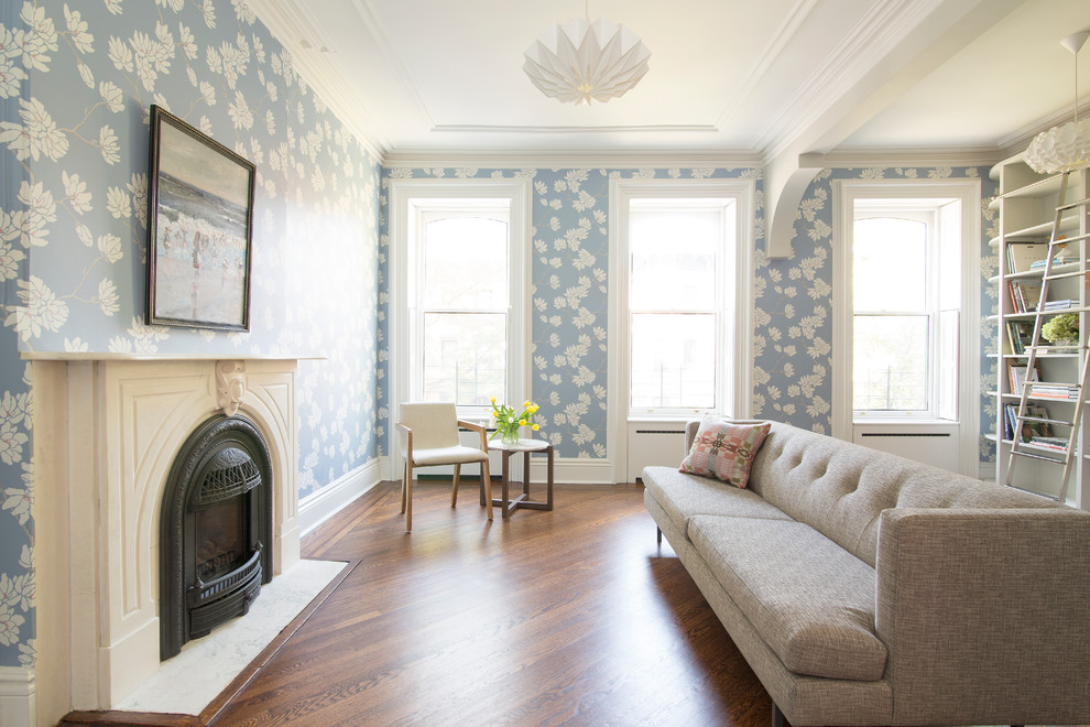 Photo of a medium sized contemporary enclosed living room in New York with a reading nook, blue walls, medium hardwood flooring, a standard fireplace, a stone fireplace surround and no tv.