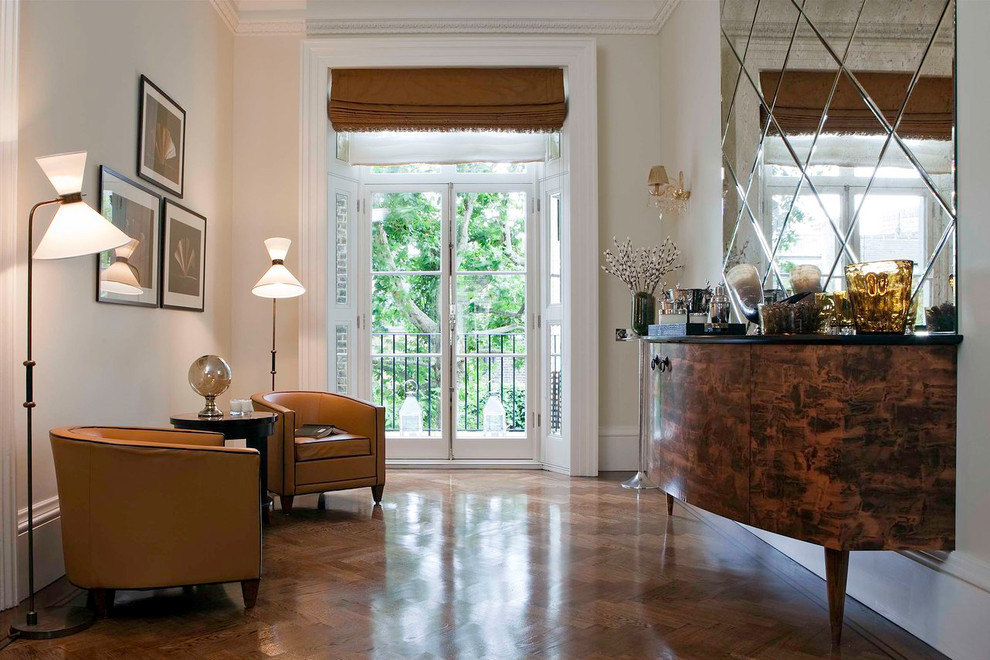 Example of a mid-sized transitional dark wood floor and brown floor living room design in London with white walls