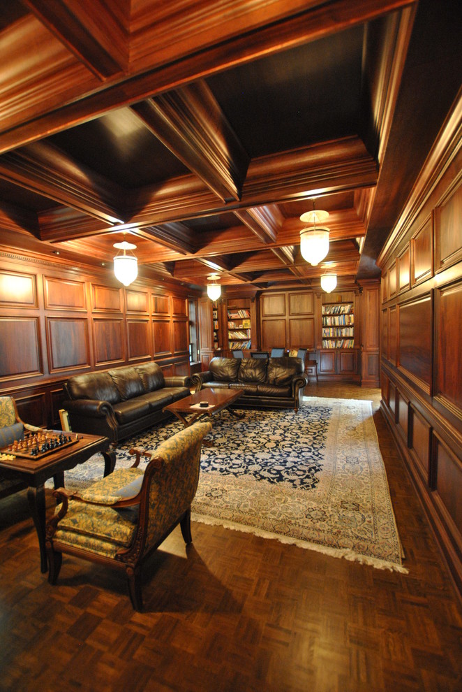 This is an example of a large classic enclosed living room in Philadelphia with a reading nook, brown walls, medium hardwood flooring, a standard fireplace, a wooden fireplace surround and no tv.