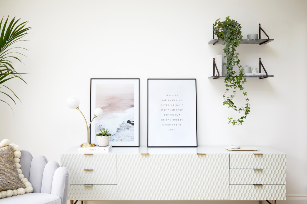 Example of a mid-sized danish open concept living room design in London with white walls and a tv stand